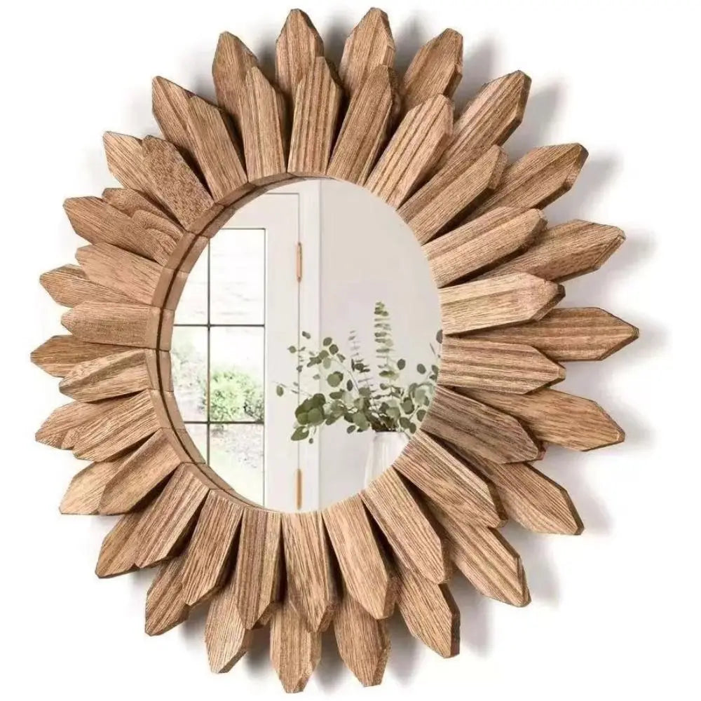 Round wooden sunflower wall mirror with layered petal design, displayed on a green accent wall in a bright, natural interior
